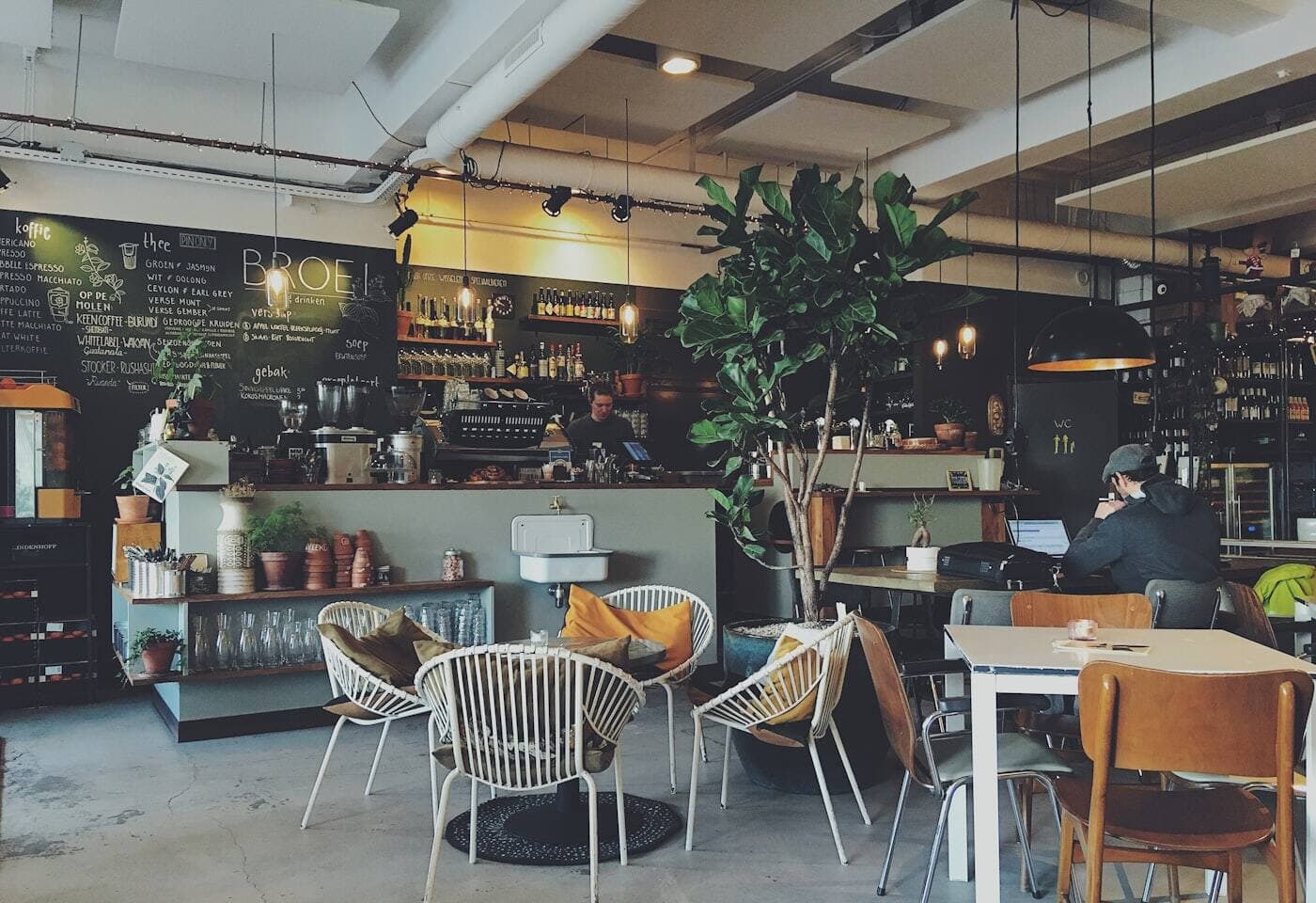 An independent café interior with a barista at the counter