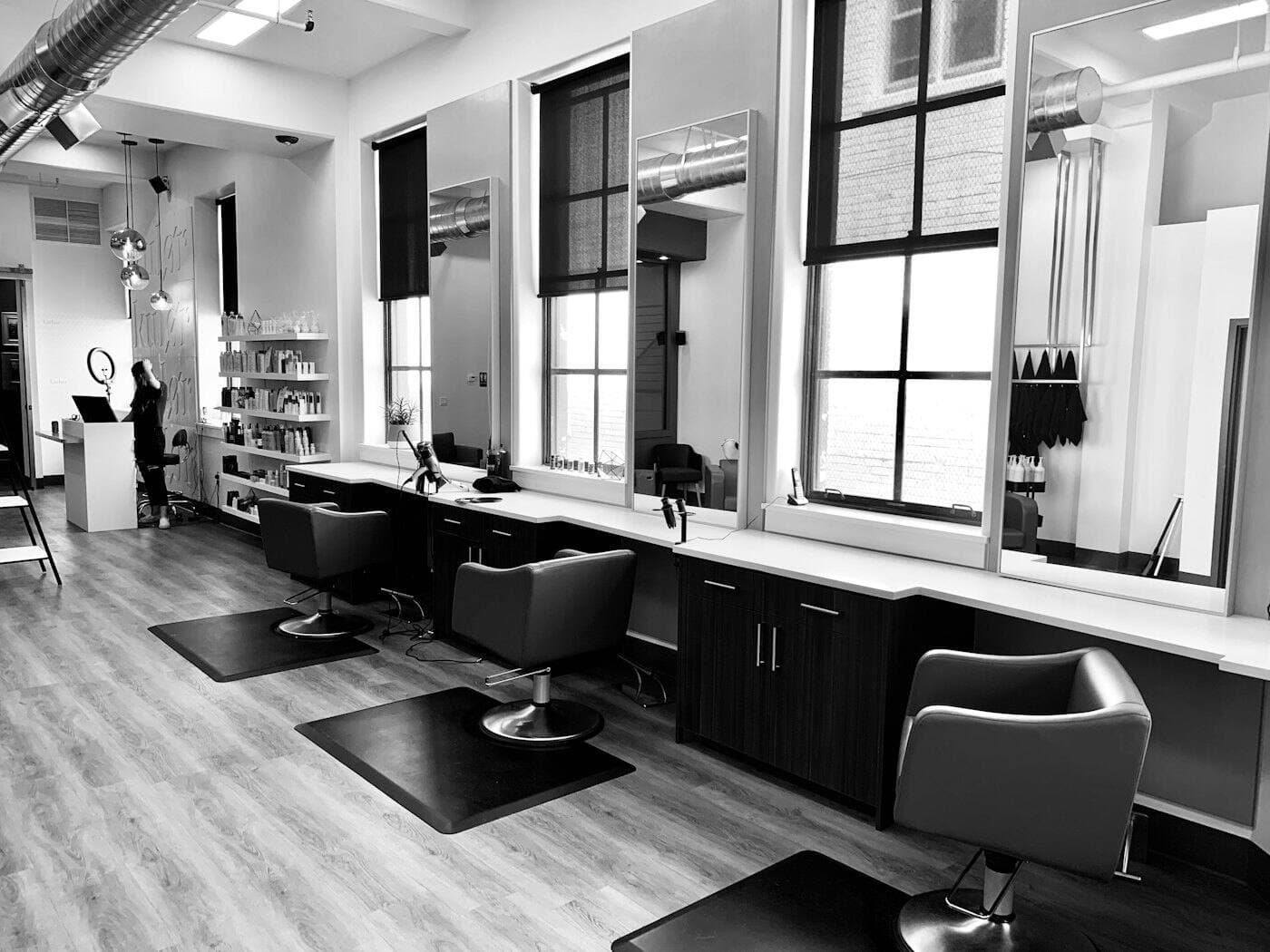 A bright hair salon with styling chairs and mirrors